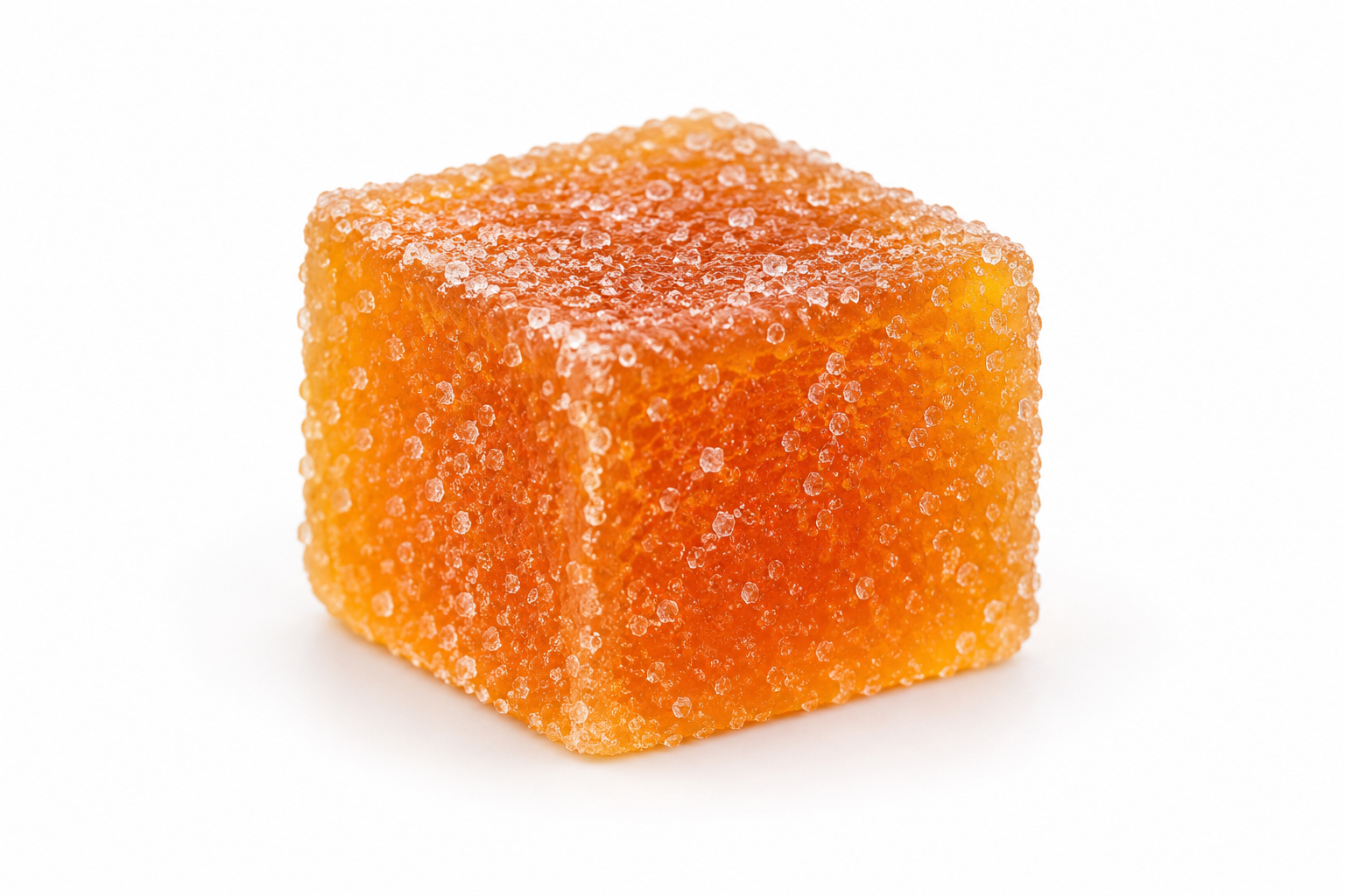 Single orange gummy on a white background